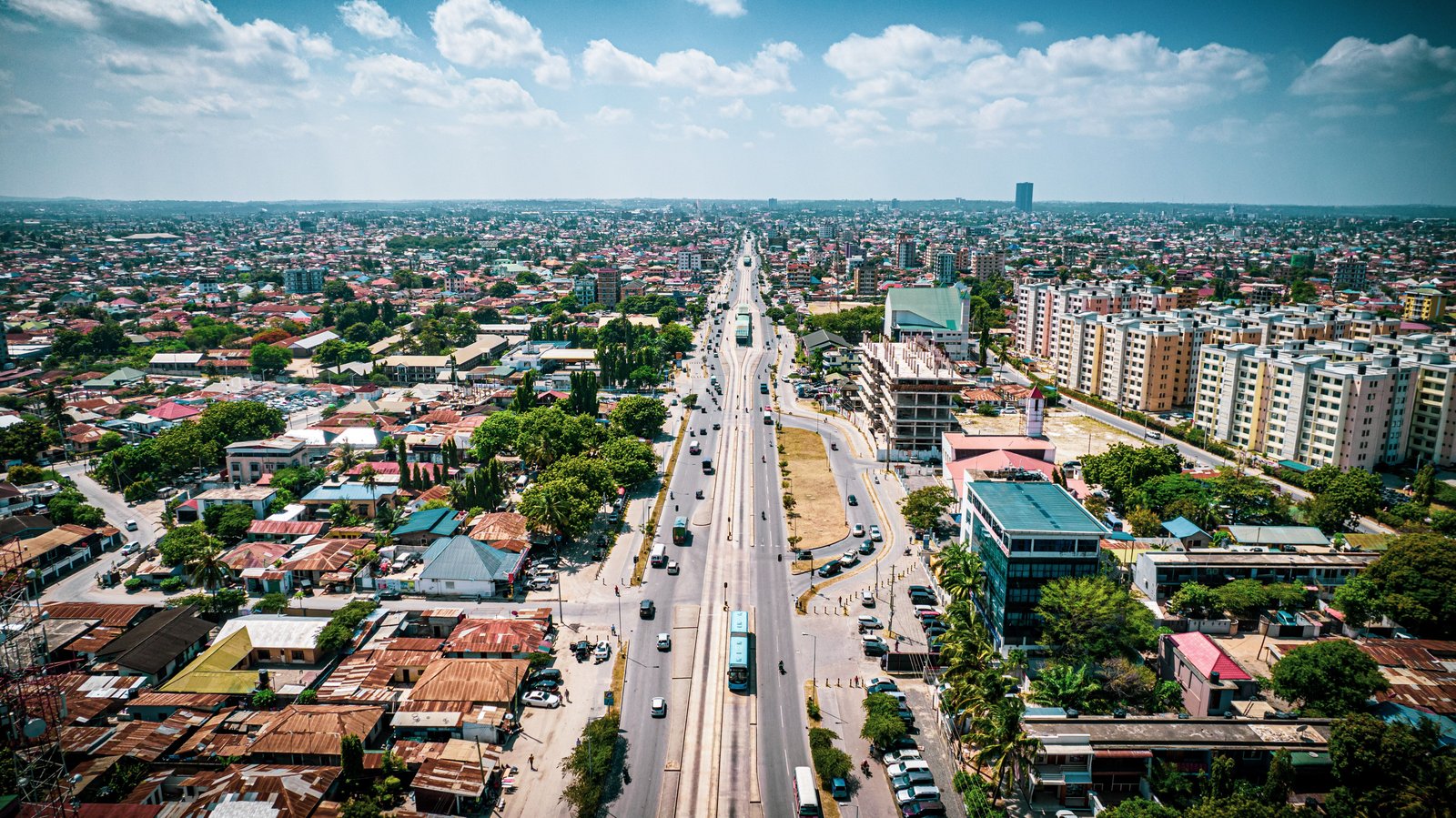 Aerial view of a growing city with a wide boulevard
